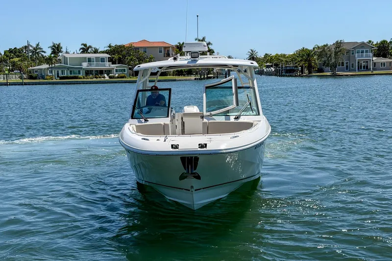Slide: The Image of 2017 Boston Whaler 320 Vantage boat cruising on a sunny waterfront. - 31