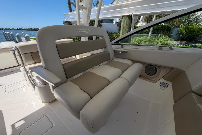 Slide: The Image of 2017 Boston Whaler 320 Vantage boat interior with comfortable seating and scenic waterfront view. - 6