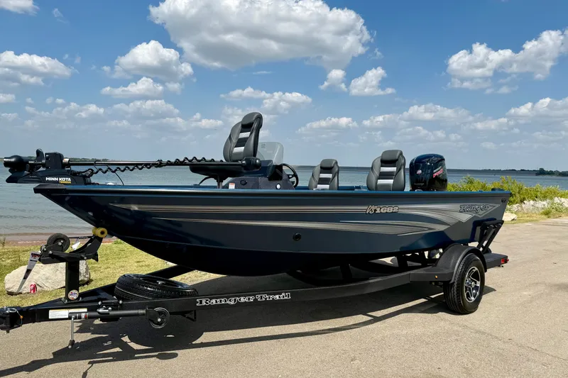 The Image of 2026 Ranger VS1682SC Angler boat on trailer by a lake under a blue sky. - 0