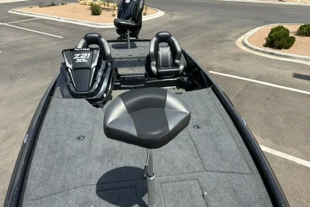 Slide: The Image of 2026 Nitro Z21 XL Pro boat with seating, parked in a lot. - 17