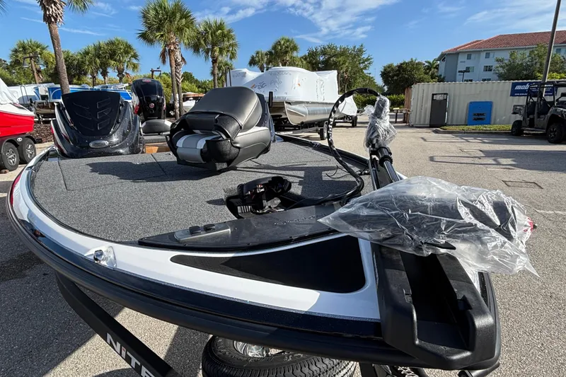 Slide: The Image of 2026 Nitro Z17 boat with seating, parked outdoors under palm trees. - 98