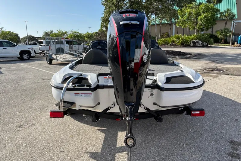 Slide: The Image of Rear view of a 2026 Nitro Z17 boat with Mercury outboard motor in a parking lot. - 93