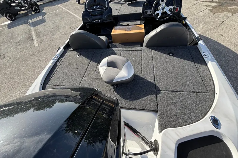 Slide: The Image of 2026 Nitro Z17 boat interior with seating and steering wheel in a parking lot. - 94