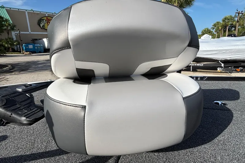 Slide: The Image of Gray and white seat on a 2026 Nitro Z17 boat, parked outdoors. - 101