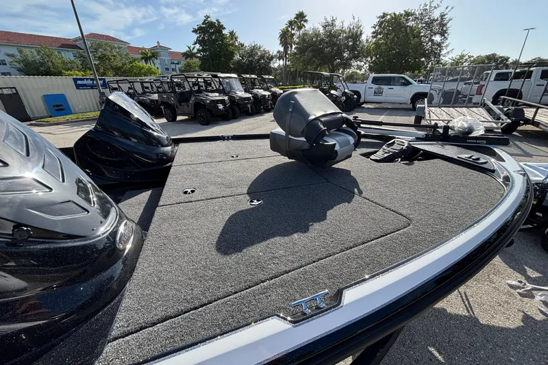 Slide: The Image of 2026 Nitro Z17 boat deck with motor, parked outdoors under clear sky. - 97