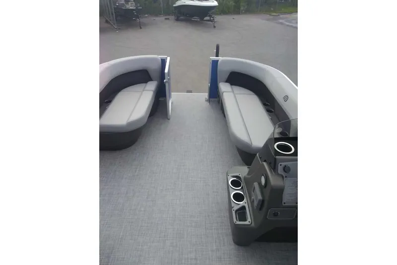 Slide: The Image of 2026 Sun Tracker Party Barge 16 DLX interior with gray seating and console. - 10