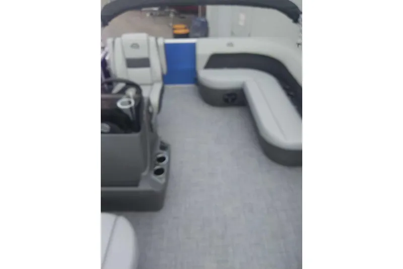 Slide: The Image of 2026 Sun Tracker Party Barge 16 DLX interior with gray seating and helm. - 13