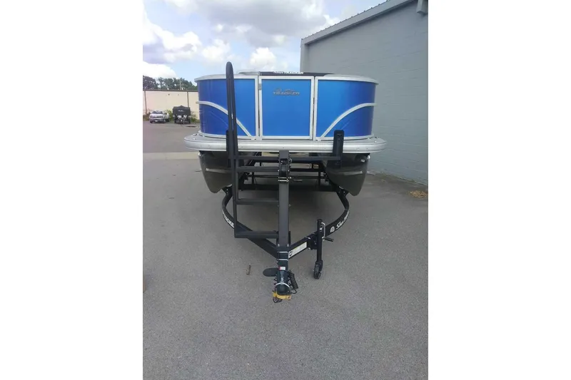 Slide: The Image of 2026 Sun Tracker Party Barge 16 DLX pontoon boat on trailer, parked outdoors. - 5