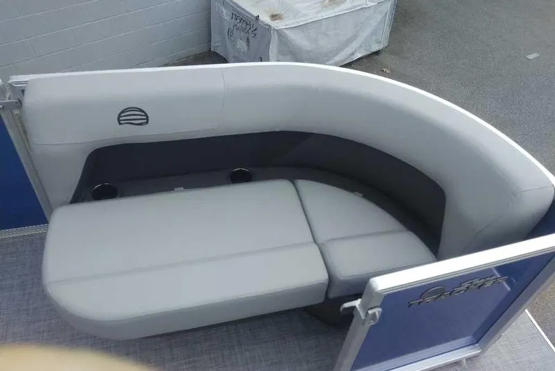 Slide: The Image of 2026 Sun Tracker Party Barge 16 DLX interior seating, featuring gray cushioned lounge area. - 7