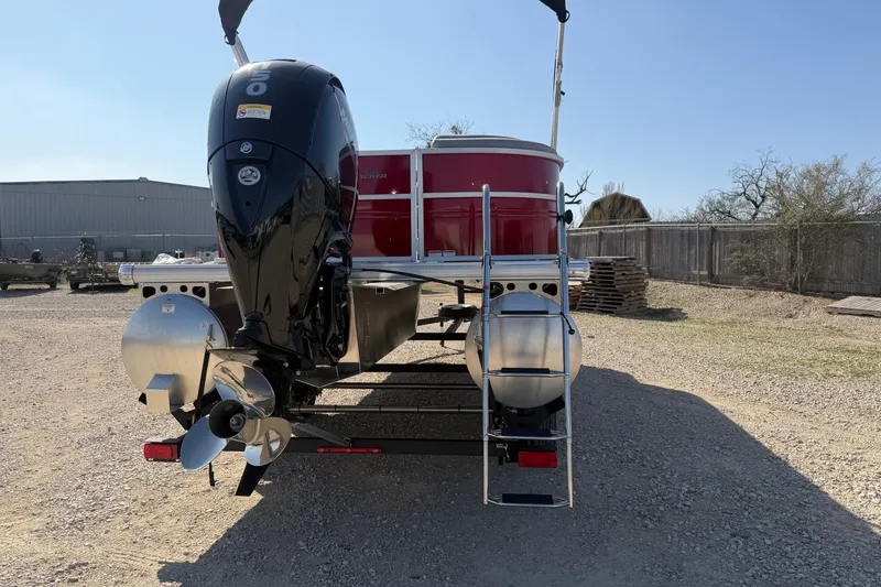 Slide: The Image of 2026 Sun Tracker Party Barge 22 DLX pontoon boat with outboard motor, rear view. - 2