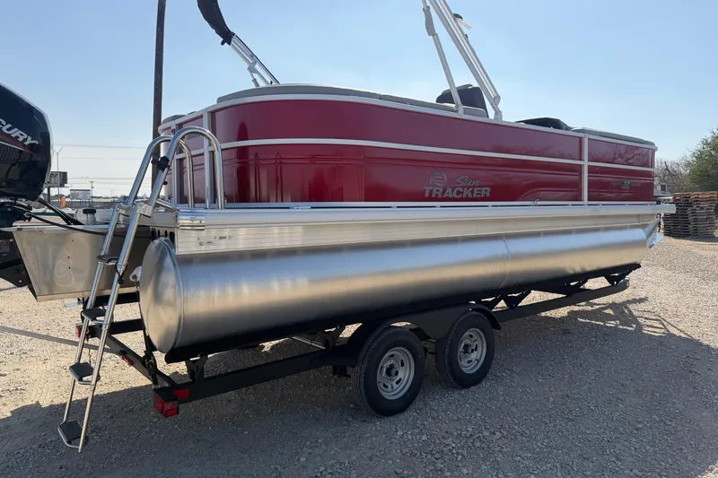 Slide: The Image of 2026 Sun Tracker Party Barge 22 DLX pontoon boat on trailer, side view. - 4