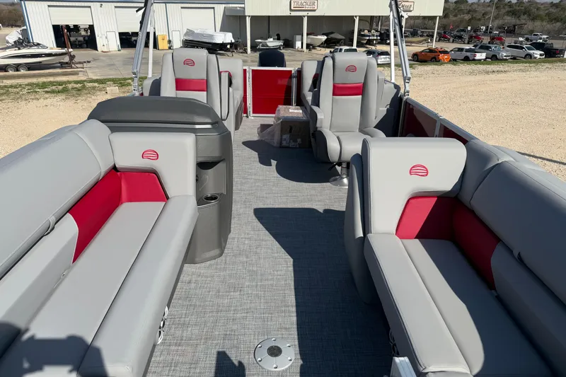 Slide: The Image of 2026 Sun Tracker Party Barge 22 DLX interior with gray and red seating, spacious layout. - 7