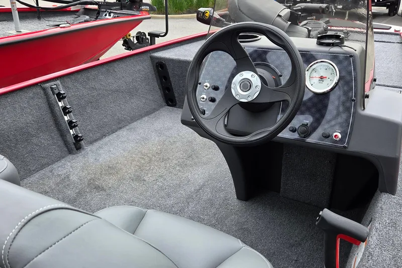 Slide: The Image of 2026 Tracker Bass Tracker Classic XL boat interior with steering wheel and dashboard. - 4