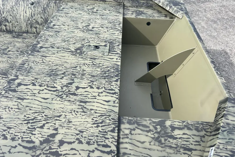 Slide: The Image of 2026 Tracker Grizzly 1648 Utility boat with camouflage pattern and open storage compartment. - 2