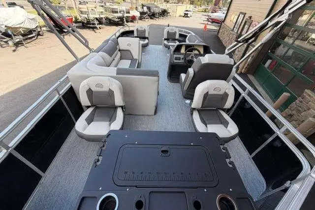 Slide: The Image of 2026 Sun Tracker Fishin' Barge 20 DLX interior with seating and helm station. - 101