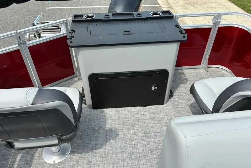 Slide: The Image of 2026 Sun Tracker SportFish 22 XP3 boat interior with seating and storage compartment. - 14