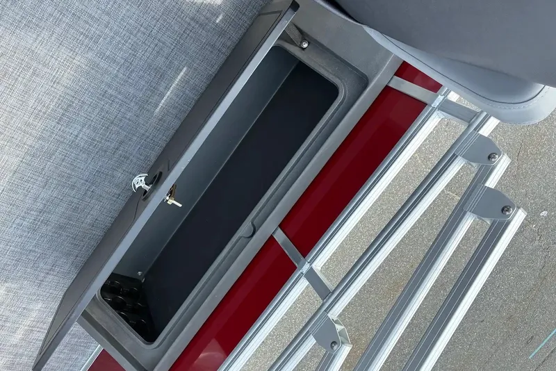 Slide: The Image of 2026 Sun Tracker SportFish 22 XP3 storage compartment with open lid, showcasing interior space. - 15