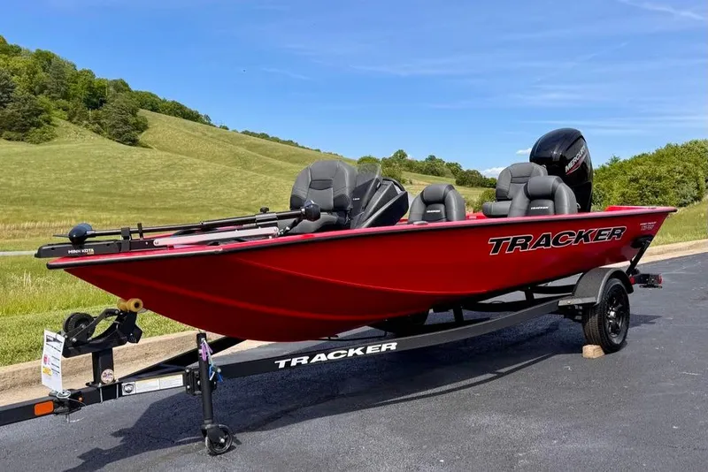 Slide: The Image of 2026 Tracker Pro Team 175 boat in vibrant red on a trailer, scenic background. - 3