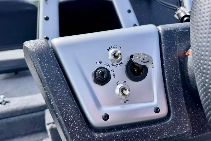 Slide: The Image of Control panel of 2026 Tracker Pro Team 175 boat with switches and ignition key. - 12