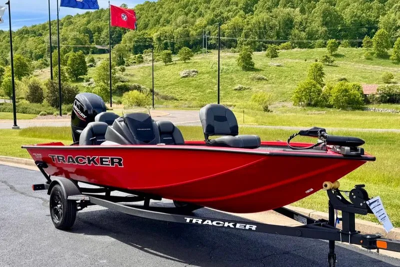 Slide: The Image of 2026 Tracker Pro Team 175 boat in vibrant red on a trailer, set against a scenic backdrop. - 2
