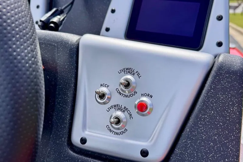 Slide: The Image of Control panel of 2026 Tracker Pro Team 175 boat with switches and horn button. - 13