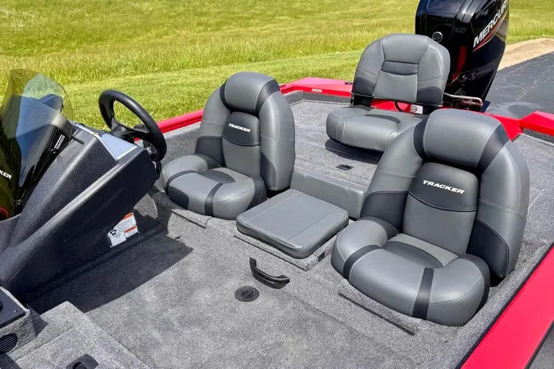 Slide: The Image of 2026 Tracker Pro Team 175 boat interior with gray seating and steering console. - 8