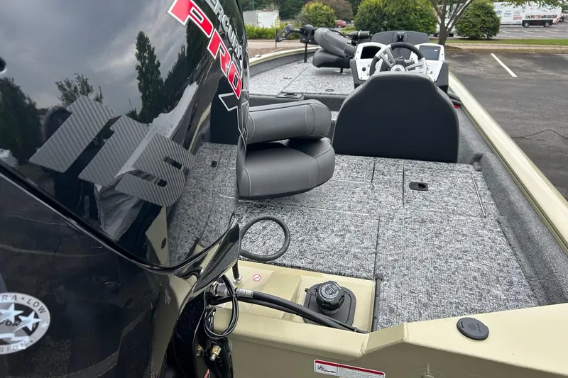 Slide: The Image of 2026 Tracker Pro Team 190 boat interior with Mercury engine, gray seating, and steering console. - 5