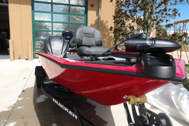 Slide: The Image of 2026 Tracker Pro Team 190 boat in vibrant red, parked outdoors. - 14