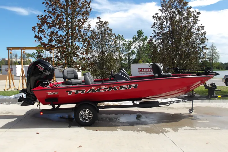 The Image of 2026 Tracker Pro Team 190 boat on trailer, red exterior, parked outdoors. - 1