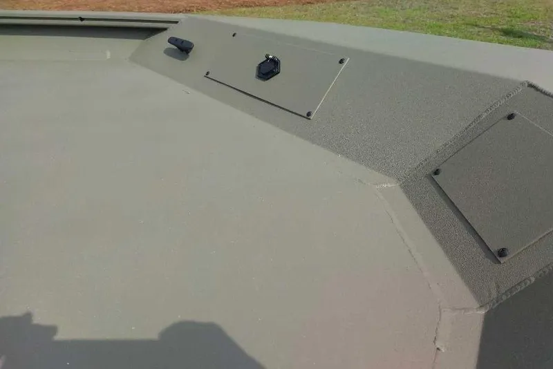 Slide: The Image of 2026 Tracker Grizzly 1860 CC boat deck, featuring a textured surface and mounted fixtures. - 2