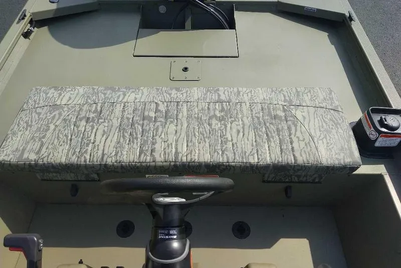 Slide: The Image of 2026 Tracker Grizzly 1860 CC boat interior with camouflage seating and steering console. - 4