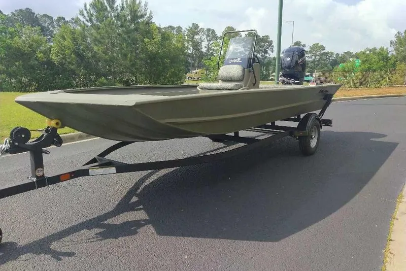 Slide: The Image of 2026 Tracker Grizzly 1860 CC boat on trailer, parked on a paved road. - 5