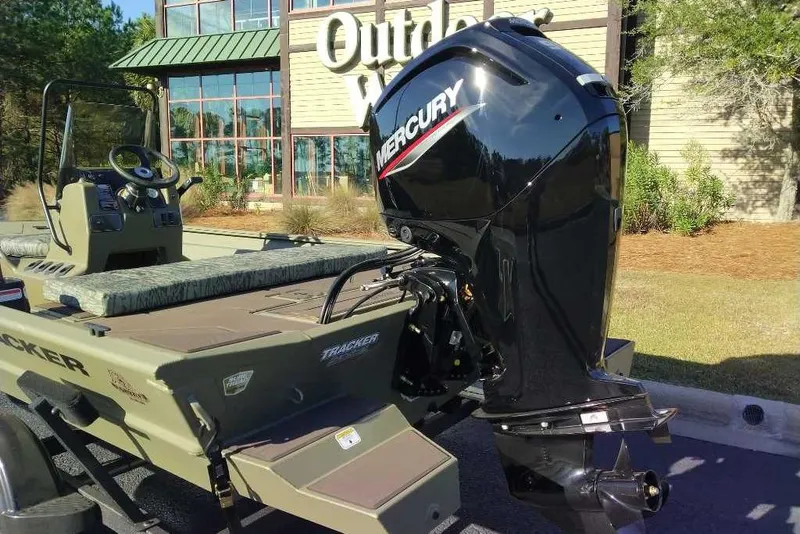 Slide: The Image of 2026 Tracker Grizzly 1860 CC boat with Mercury engine outside a store. - 6