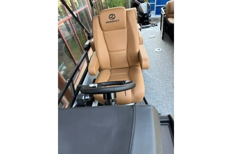 Slide: The Image of Luxurious tan captain's chair in 2026 Regency 230 DL boat interior. - 21