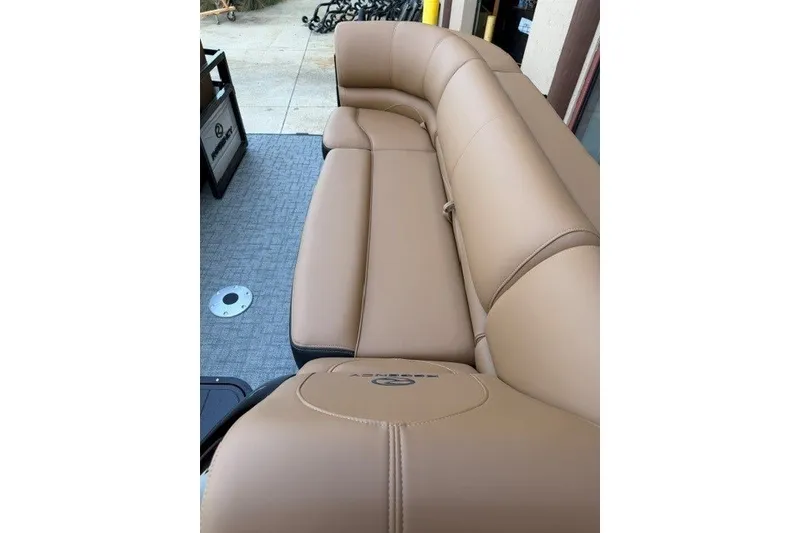 Slide: The Image of Luxurious tan seating on 2026 Regency 230 DL boat, showcasing comfort and style. - 18
