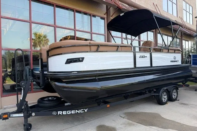 The Image of 2026 Regency 230 DL pontoon boat on trailer, featuring sleek design and modern amenities. - 0