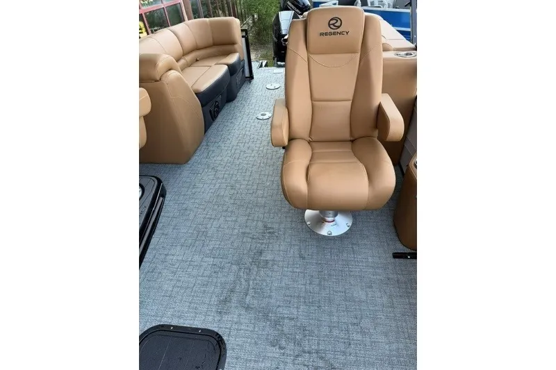 Slide: The Image of Luxurious seating on 2026 Regency 230 DL boat with tan upholstery and carpeted flooring. - 22