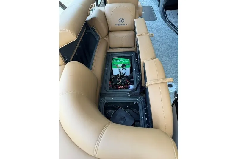 Slide: The Image of Tan leather seating with open storage compartment in 2026 Regency 230 DL boat. - 15