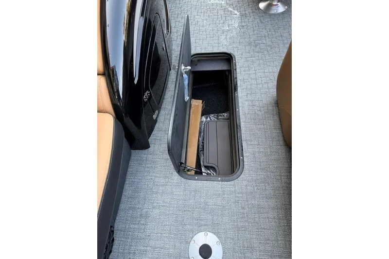 Slide: The Image of Open storage compartment on 2026 Regency 230 DL boat with gray flooring. - 23