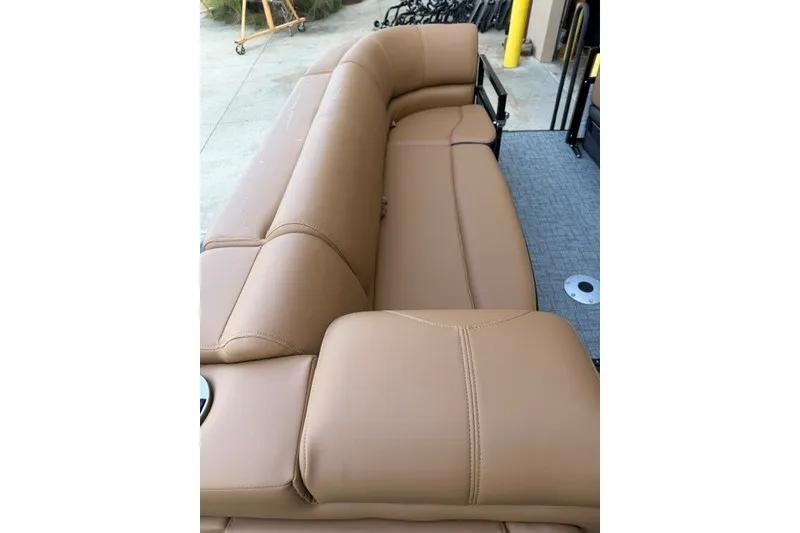 Slide: The Image of Luxurious tan seating on 2026 Regency 230 DL boat, showcasing comfort and style. - 14