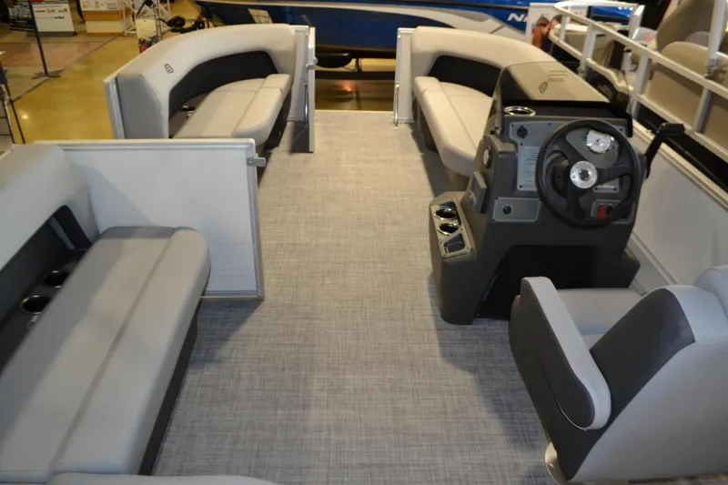 Slide: The Image of 2026 Sun Tracker Party Barge 16 DLX interior with spacious seating and modern helm. - 1