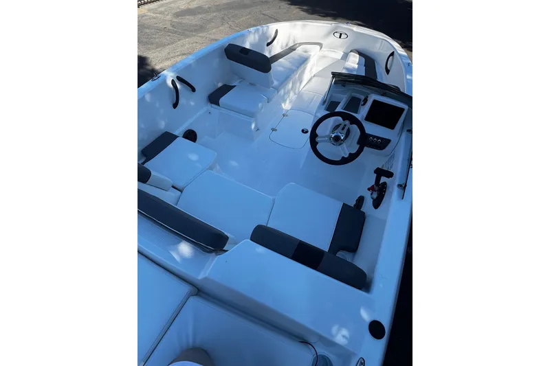 Slide: The Image of 2026 Tahoe T16 boat interior with sleek seating and modern steering console. - 7