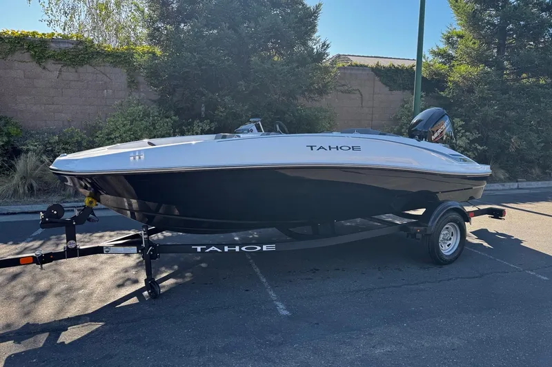 Slide: The Image of 2026 Tahoe T16 boat on trailer in sunny outdoor setting. - 3