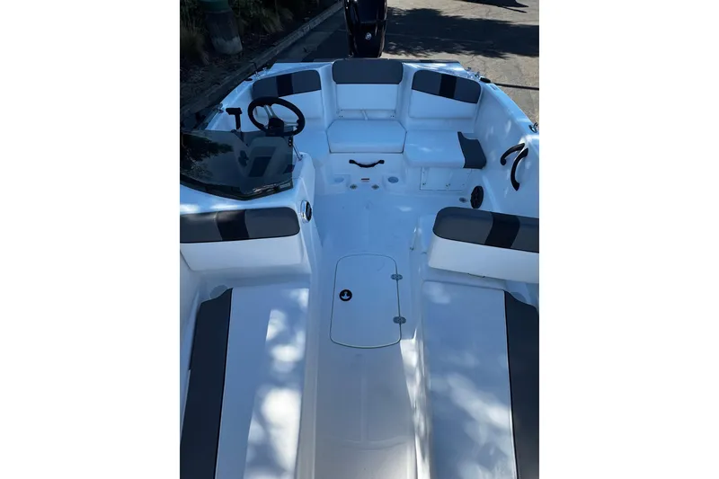 Slide: The Image of 2026 Tahoe T16 boat interior with sleek seating and modern steering console. - 9
