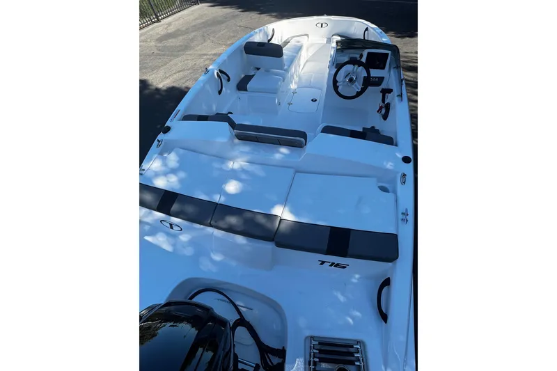 Slide: The Image of 2026 Tahoe T16 boat with sleek design, spacious seating, and modern steering console. - 8