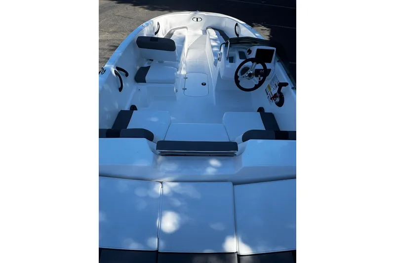 Slide: The Image of 2026 Tahoe T16 boat interior with seating and steering wheel, showcasing modern design. - 12