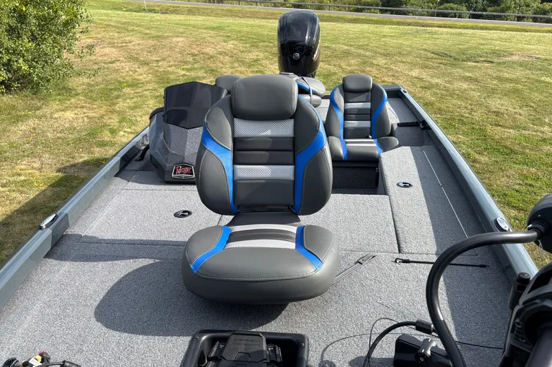 Slide: The Image of 2026 Ranger RT178 boat interior with gray and blue seating on grassy background. - 4
