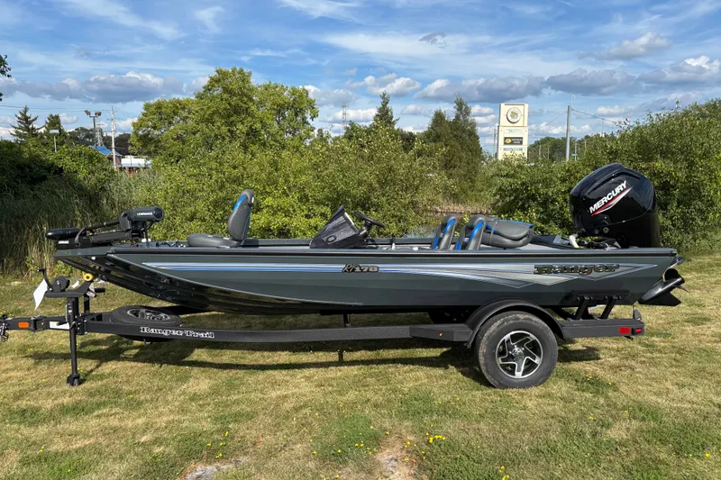 The Image of 2026 Ranger RT178 boat on trailer, parked on grass under a blue sky. - 0