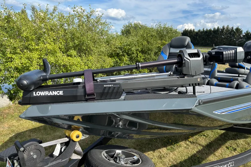 Slide: The Image of 2026 Ranger RT178 boat with Lowrance Ghost trolling motor, parked on grass. - 3