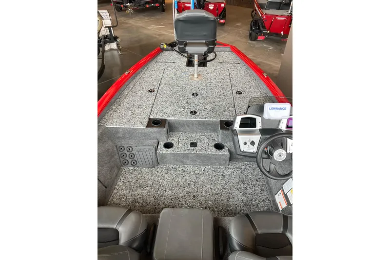 Slide: The Image of 2026 Tracker Pro Team 195 boat interior with gray carpet and steering console. - 4